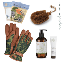 Gardeners Gift Hamper including gloves, a scrub brush, hand care products and a gift card with culinary flower seeds.