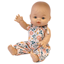 Baby doll wearing a floral outfit on a white background