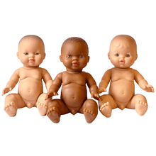 Three dolls with different skin tones on a white background