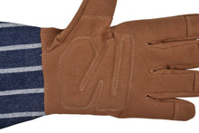 A close-up of a brown leather work glove worn over a navy and white striped shirt, showing the back of the hand with stitched paneling on a white background.